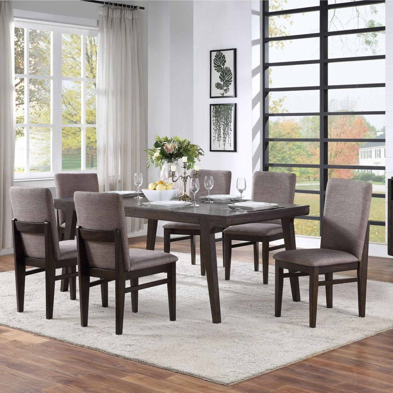Olejo Dining Table in a beautifully styled dining room with modern chairs and decor.