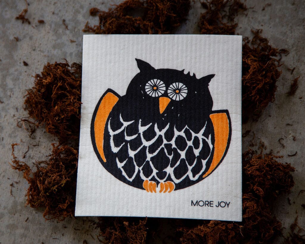 Owl Swedish Dishcloth in orange and black design on textured background featuring a detailed owl illustration.