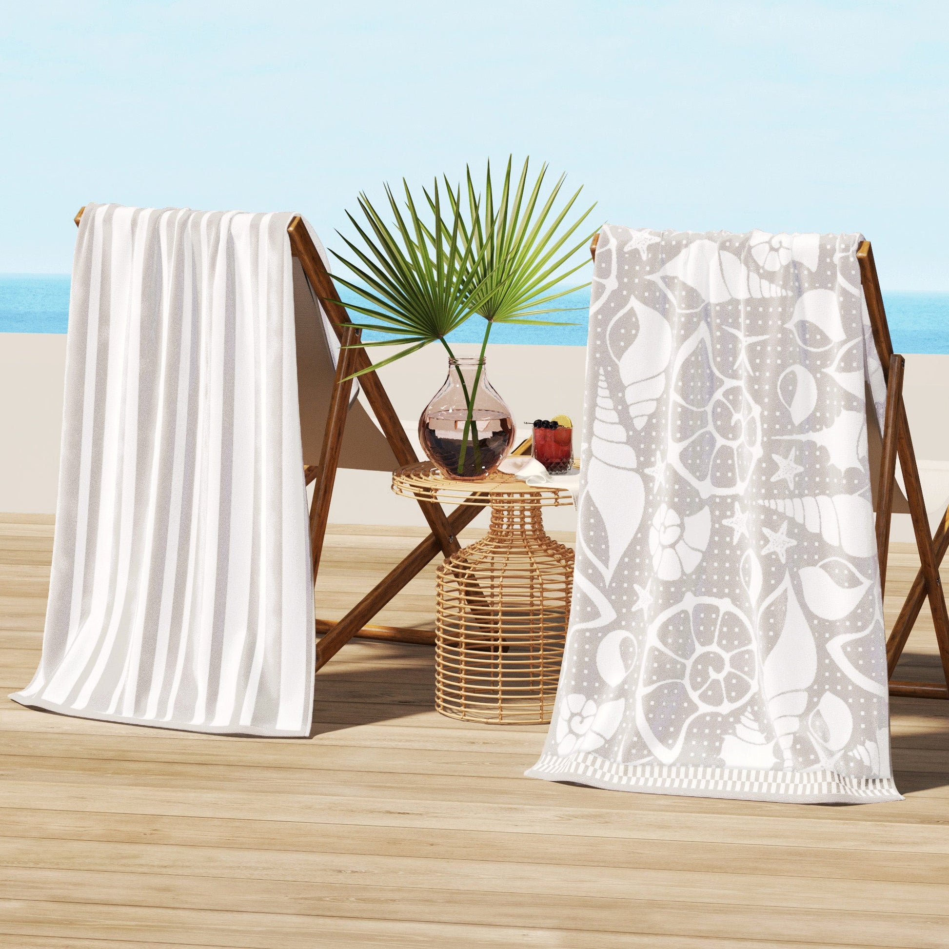Two beach towels on wooden chairs with a beach setting in the background