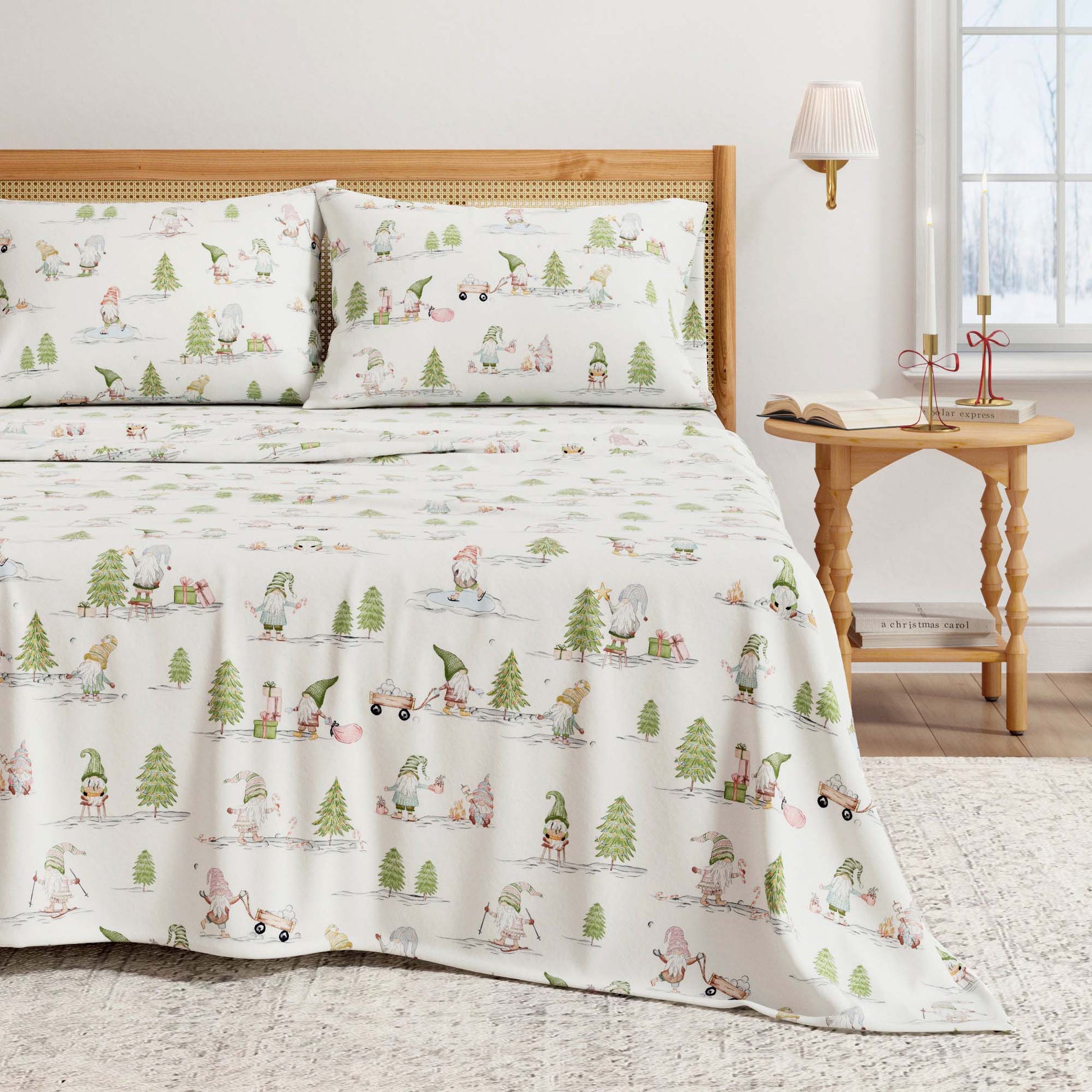 Bed with a gnome patterned comforter and pillows in a room with a side table and lamp.