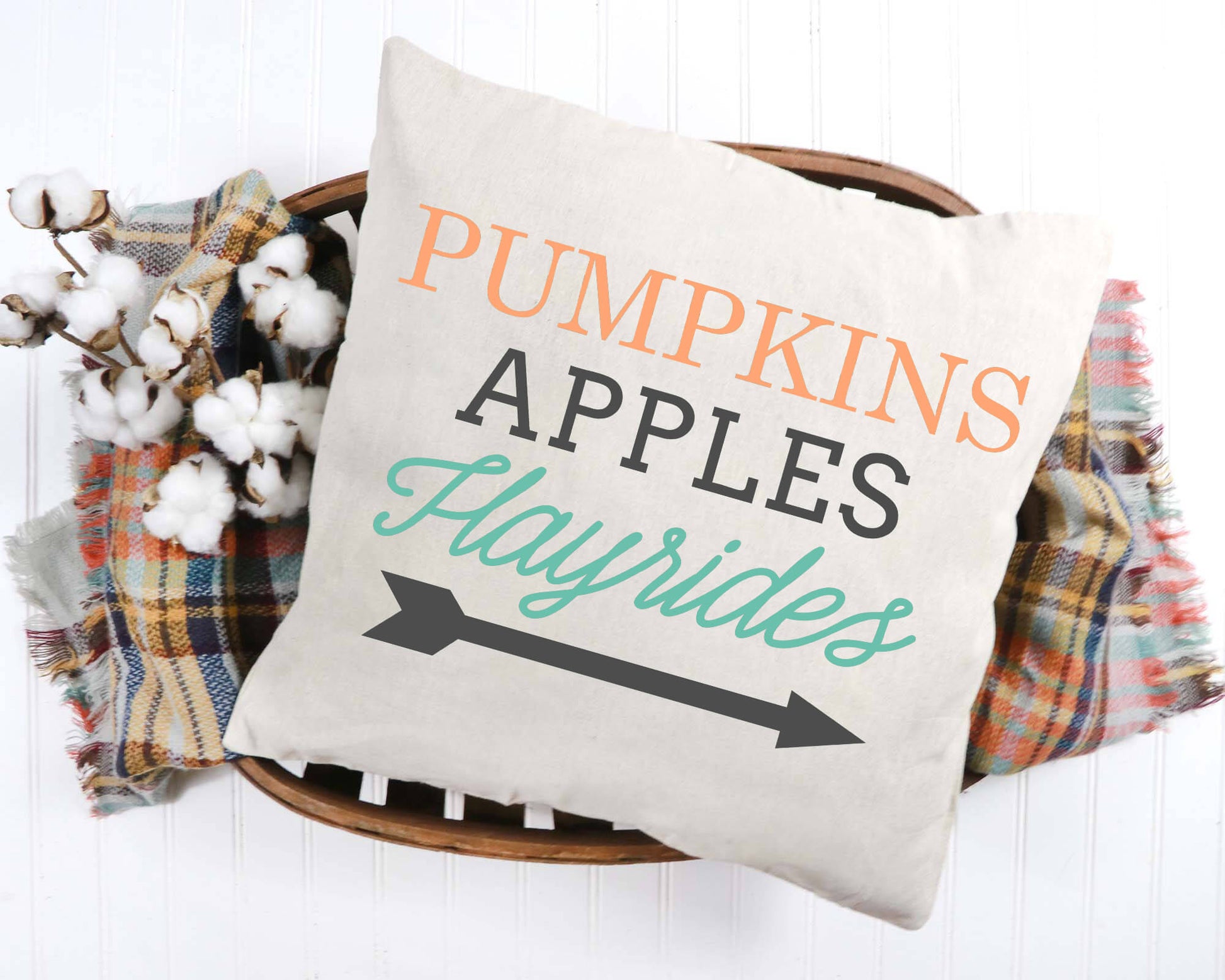 Pumpkins Apples Hayrides Pillow Cover 18x18 inch with cozy cotton fabric displayed on a basket.