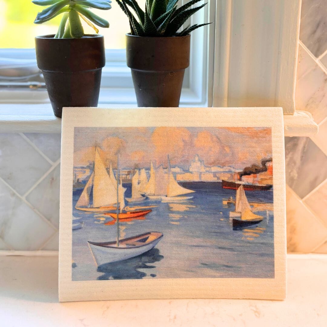 Swedish dishcloth of sailboats on water with potted plants in the background