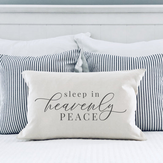 Sleep in Heavenly Peace Pillow Cover 12x20 inch displayed on a bed with striped pillows, creating a cozy holiday atmosphere.