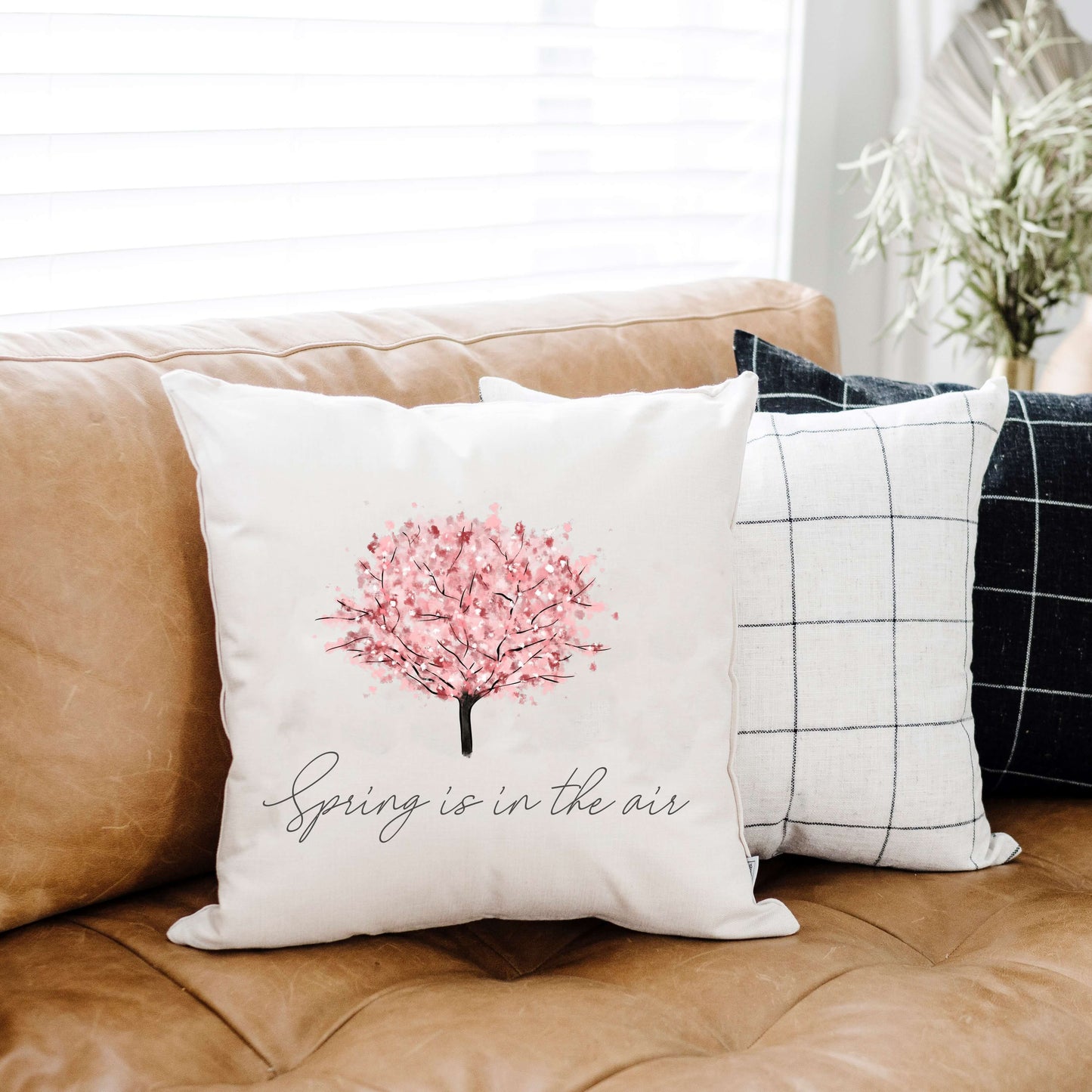 Cherry Blossom Tree Pillow Cover 18x18 inch on a couch, perfect for spring decor accents.