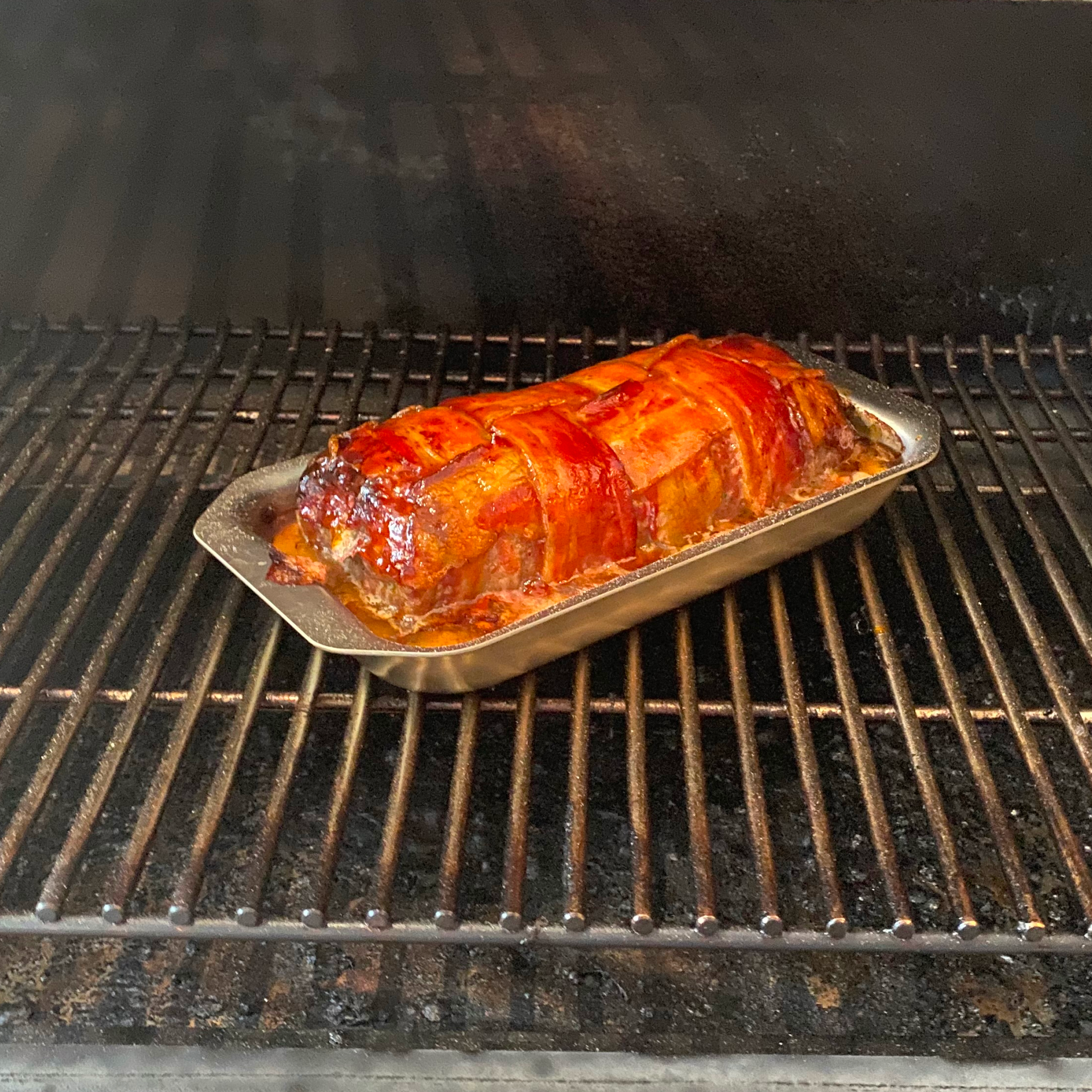 Meatloaf on a baking tray on a grill