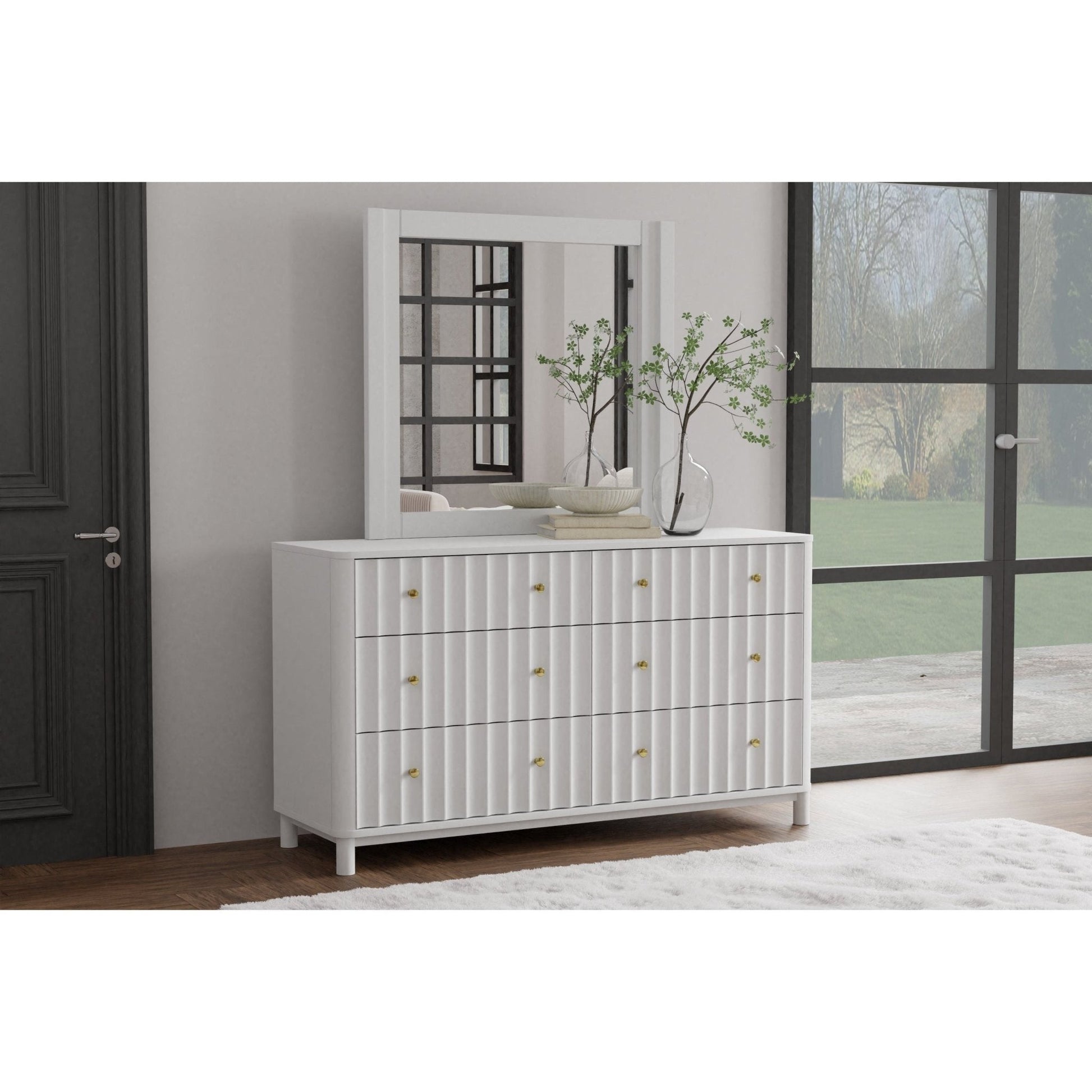 Stapleton Mirror above a white dresser with a plant on top, stylishly enhancing modern bedroom decor.