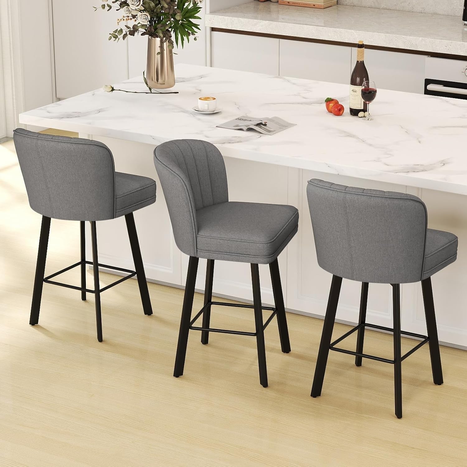 26 Counter Height Bar Stools Set Of 3 Gray Faux Leather arranged around a kitchen island with a marble countertop.