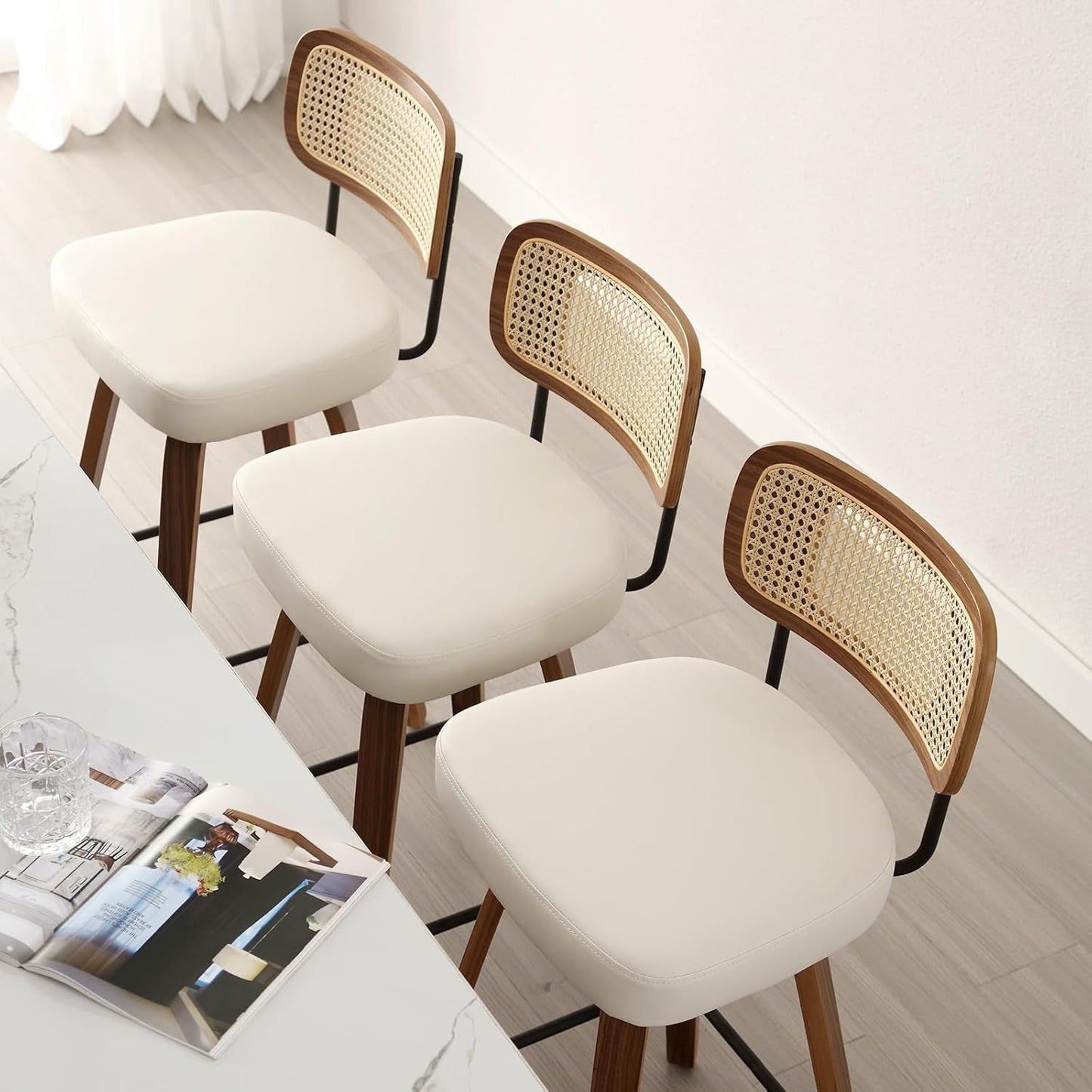 Swivel Counter Height Bar Stools Set of 4 Cream Upholstered Rattan Back in a modern kitchen setting