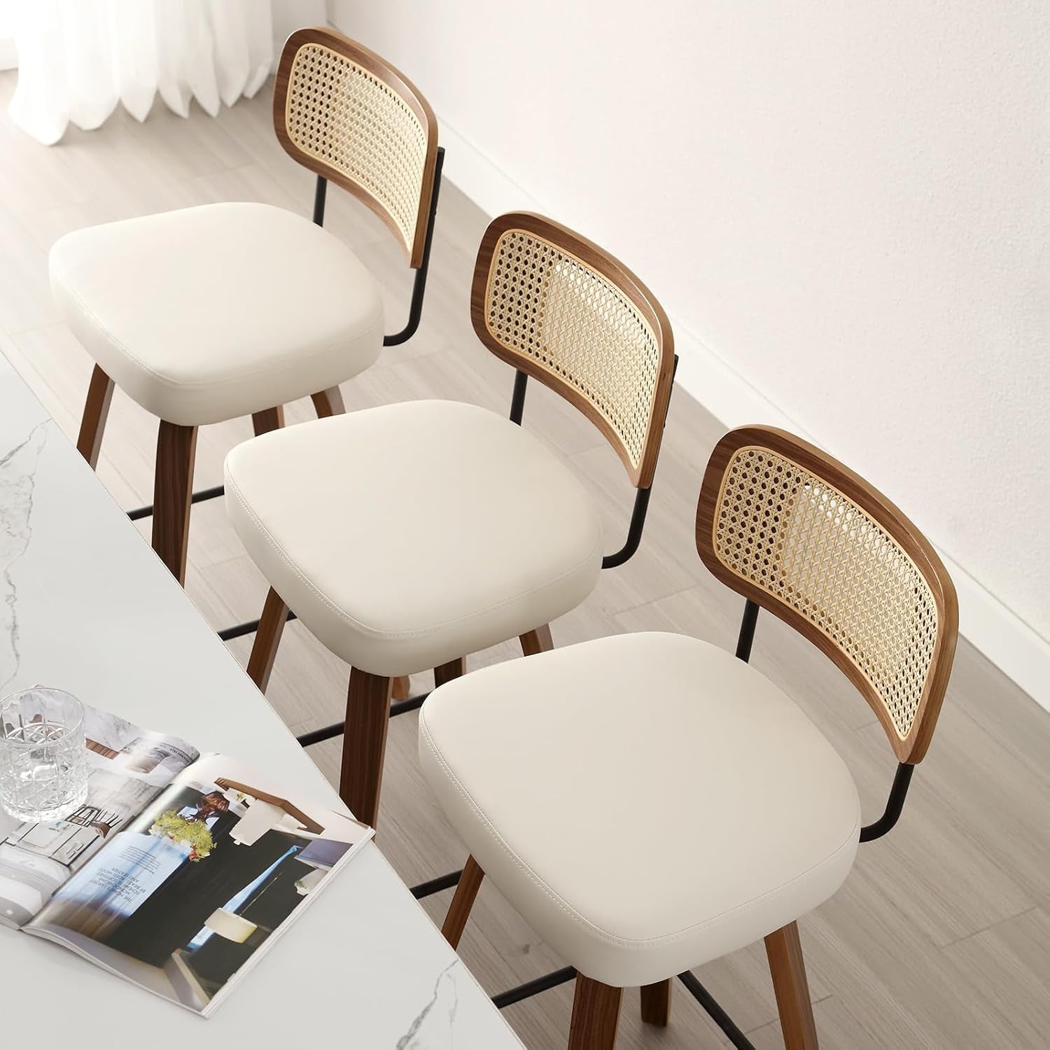 Swivel Counter Height Bar Stools Set of 4 Cream Upholstered Rattan Back in a modern kitchen setting