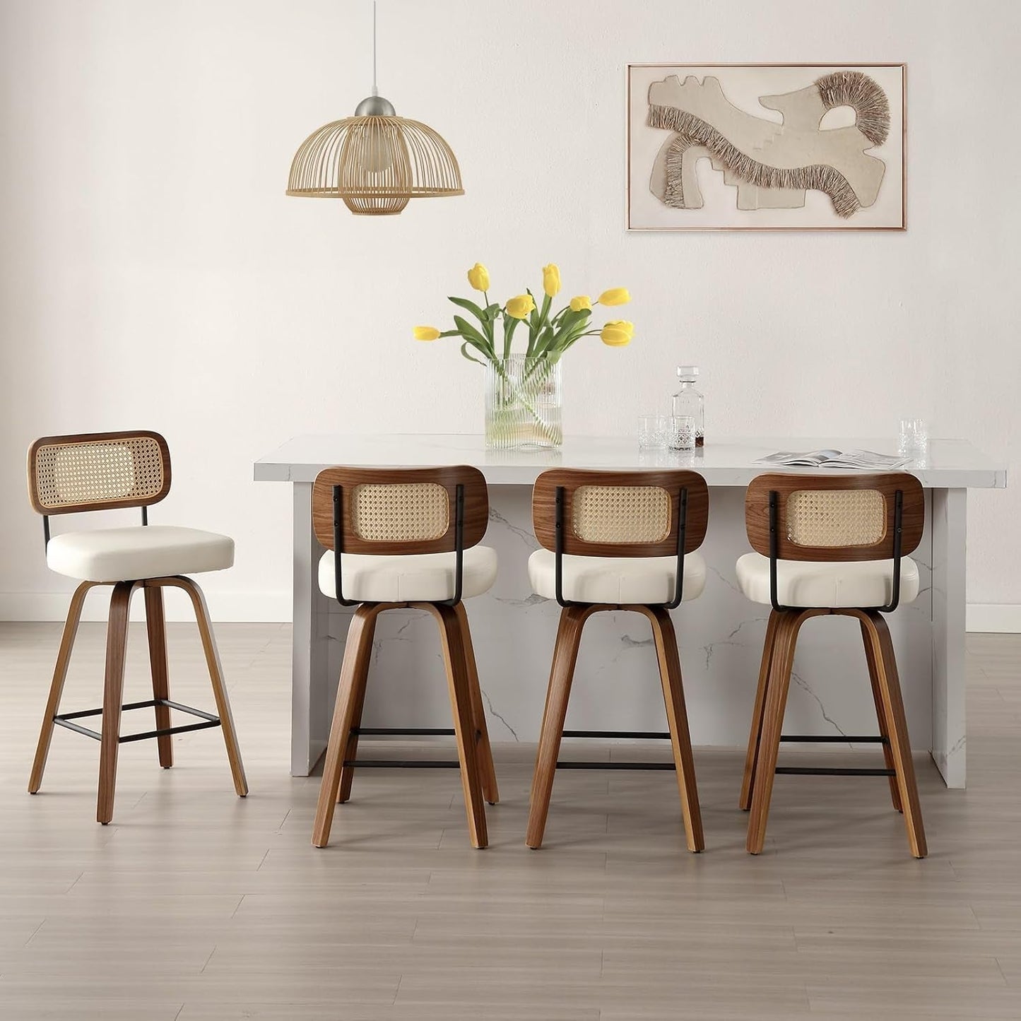 Swivel Counter Height Bar Stools Set of 4 Cream Upholstered Rattan Back arranged around a kitchen island with flowers