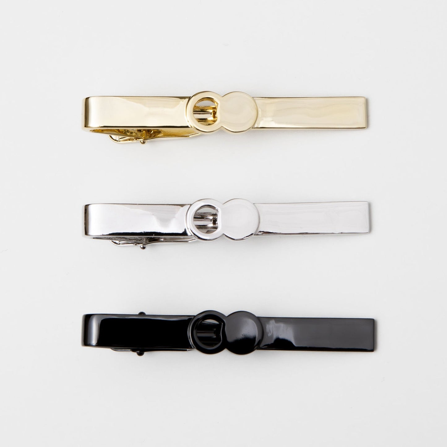 The Empty Tomb Tie Clip in gold, silver, and black showcasing sleek and stylish design.