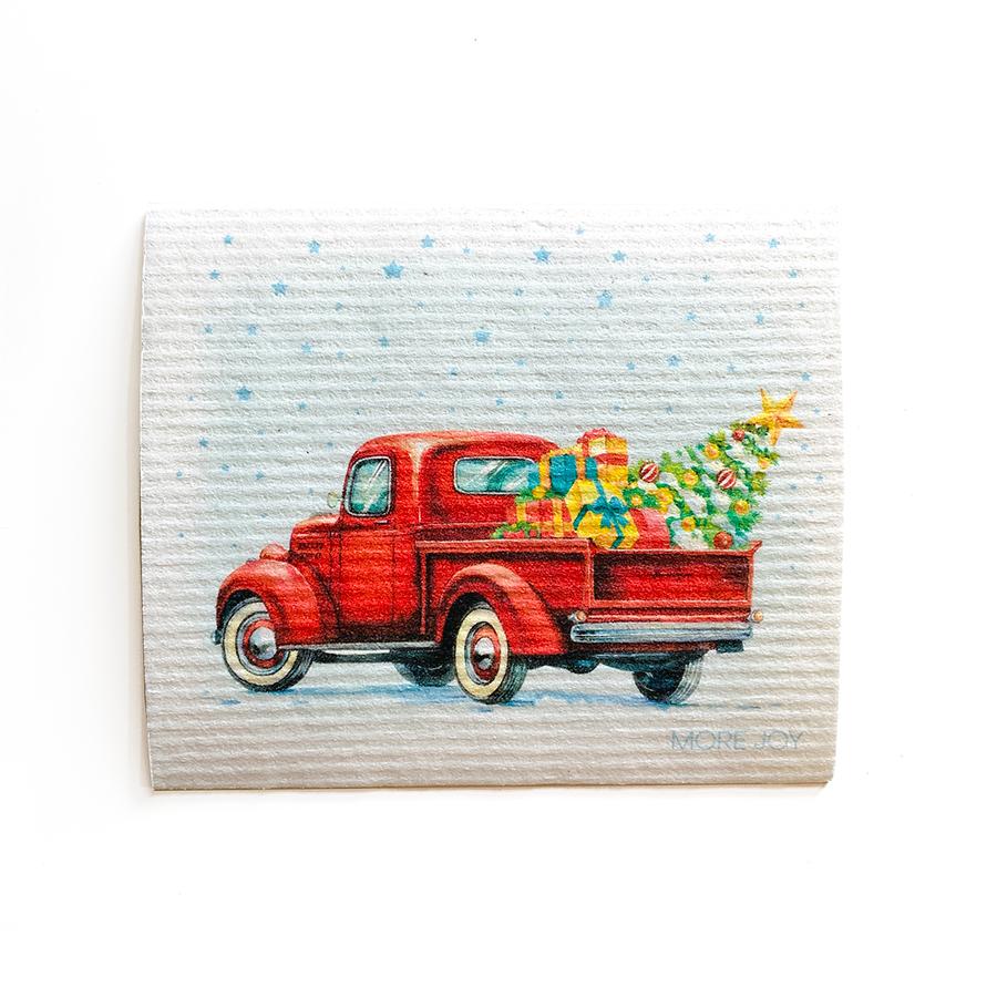 Vintage Truck with Christmas Tree Swedish Dishcloth featuring a red truck carrying Christmas gifts and a Christmas tree.