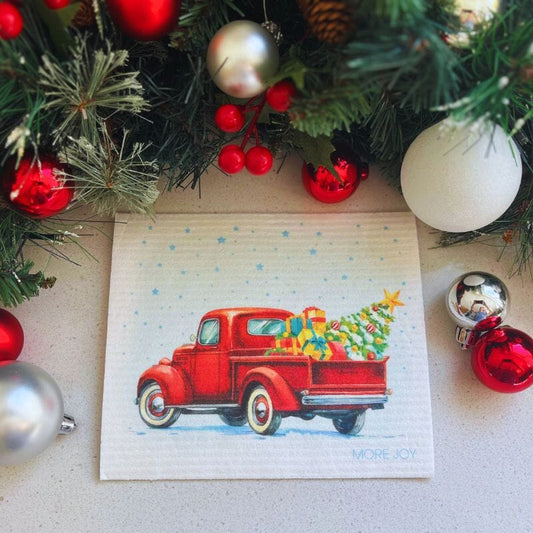 Vintage Truck with Christmas Tree Swedish Dishcloth featuring a red truck filled with gifts and a Christmas tree.