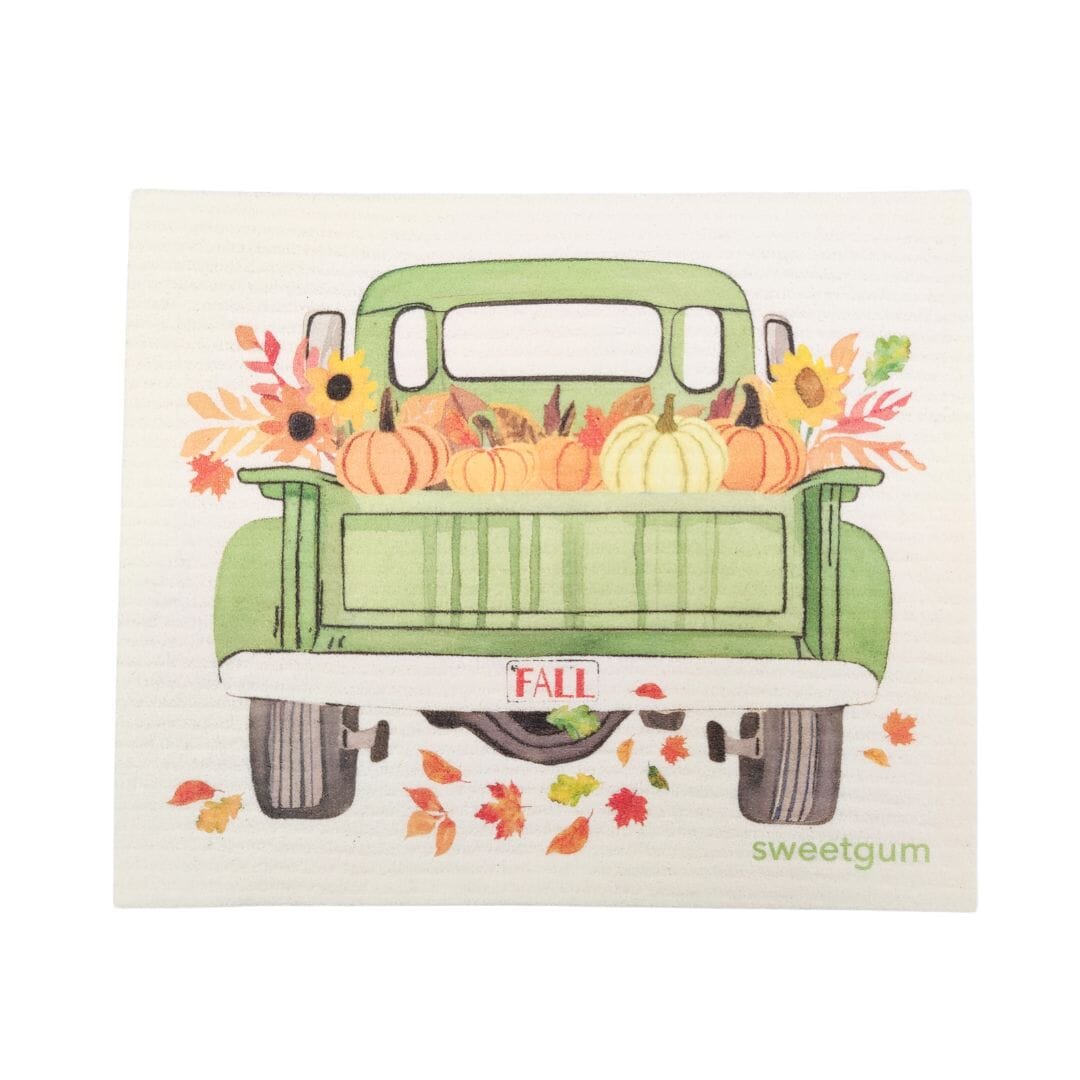 Illustration of a green truck with pumpkins and fall decorations on a white background, featuring the brand 'sweetgum'.