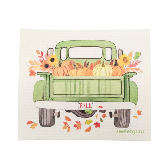 Illustration of a green truck with pumpkins and fall decorations on a white background, featuring the brand 'sweetgum'.