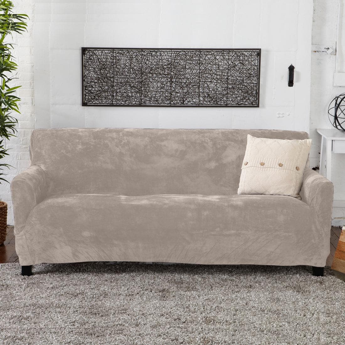 Beige sofa with a pillow in a living room setting