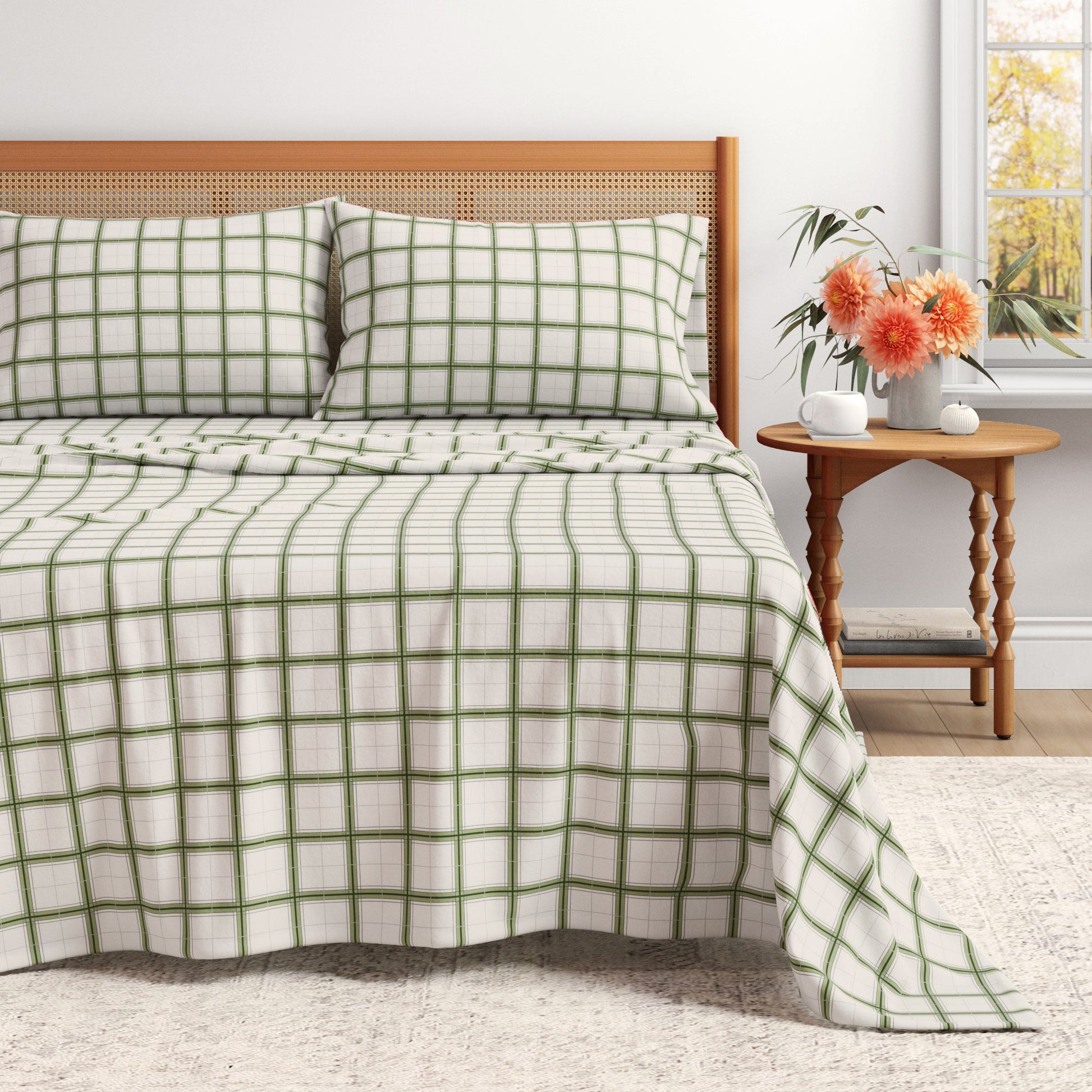 Bed with green and white checkered bedding in a bedroom setting.