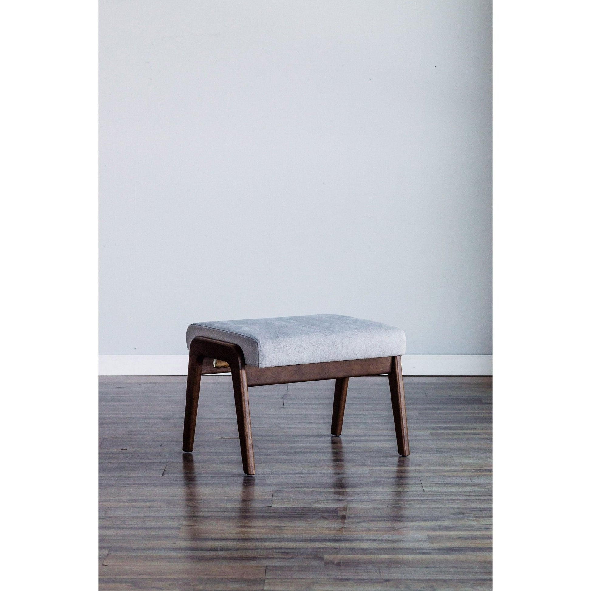 Zephyr Slate Footrest with light gray upholstery and medium brown solid wood frame in modern room setting.